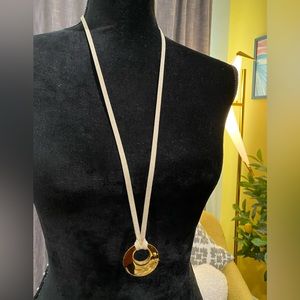 NWOT Banana Republic gold crescent pendant on grey suede necklace.